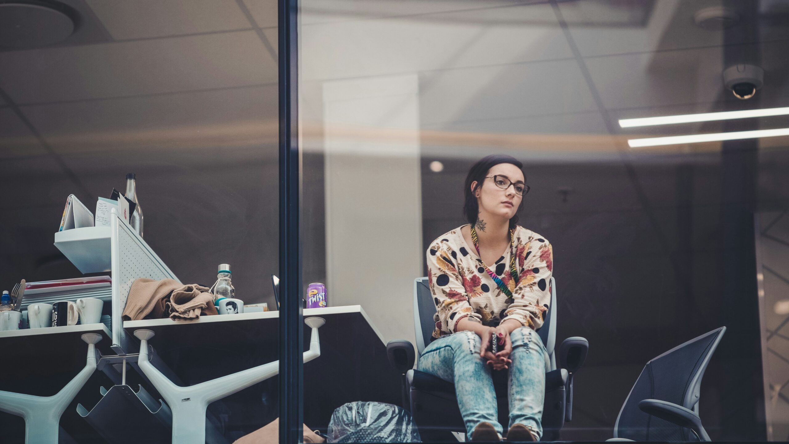 Woman staring out of her office window feeling apathy. 